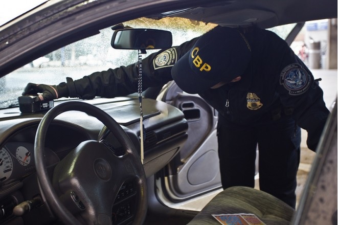 A CBP officer inspecting a car (photo) 
