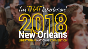 2018 Libertarian National Convention logo over color photo of convention delegates, lettering 'I'm THAT Libertarian!' and ' 2018 New Orleans' and 'Libertarian National Convention' in gold and white (color graphic)