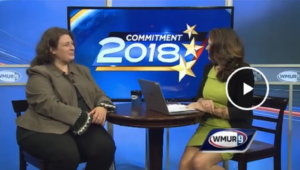 Jilletta Jarvis at left, Amy Coveno at right, seated in TV studio on stools at bar table with TV screen backdrop, labeled 'Commitment 2018', and 'WMUR 9' logo in lower right corner (color image of TV screen)