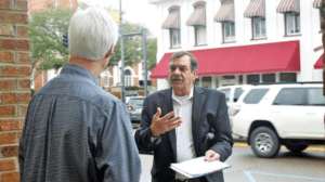Danny Bedwell asks a pedestrian to sign a petition in Lowndes County, Miss